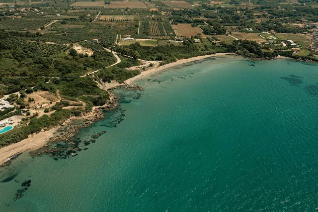 Aerial view of the coastline and bay at Leventochori beach