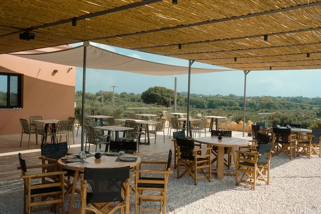 The wide outdoor dining area under the shade sails at Leventes