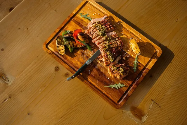Grilled beef striploin sliced on a wooden board, from the Leventes Mediterranean menu