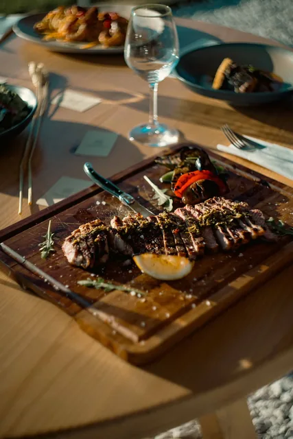 Steak board served at the table with wine and sides