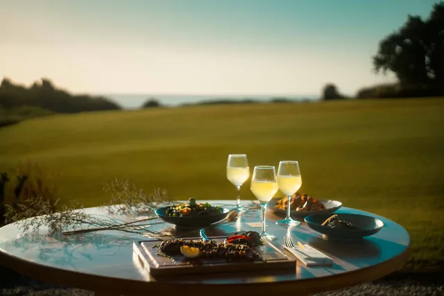 Table set for dinner above the lawn at golden hour
